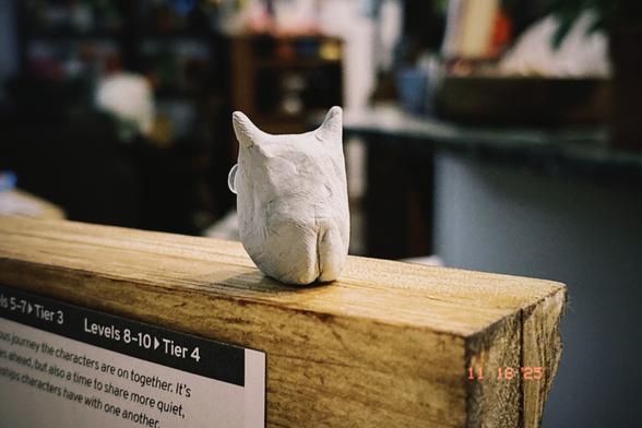 Same picture except the devil guy is turned around showing tiny butt cheeks.