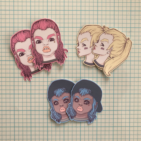 three illustrated portrait stickers depicting angry-faced teens with pink, yellow and blue hair.