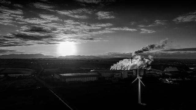 Aerial Monochrome shot over factory at sunrise