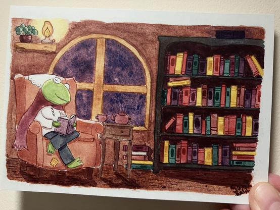 Art print of a watercolour painting of Terry, a frog mage, reading books in his cozy reading nook.