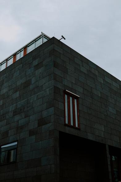 photo of a minimalistic building with clean sides and windows with wooden frames