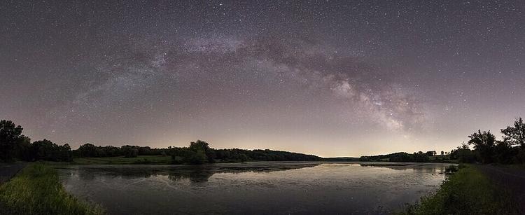 Panorama of the Milky Way galactic plane stretching over Bontecou Lake in Dutchess County, New York.