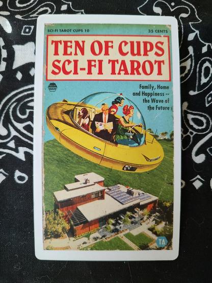 Card from the Sci Fi Tarot by Todd Alcott. 
Ten of Cups.
A family in a futuristic flying saucer flying over a home. Note the nice solar panels on the house's roof.