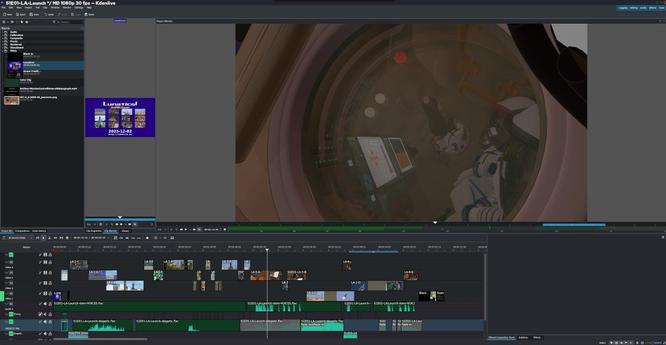 Scene in Kdenlive, with timeline clips at the bottom. The video is frozen on the reflection shot from the porthole, which reflects the console and seated astronauts.