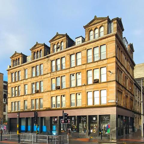 A blonde sandstone Victorian warehouse in Glasgow.