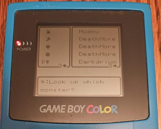 Photo of a game boy colornwith dragon warrior monsters showing a completed monster library