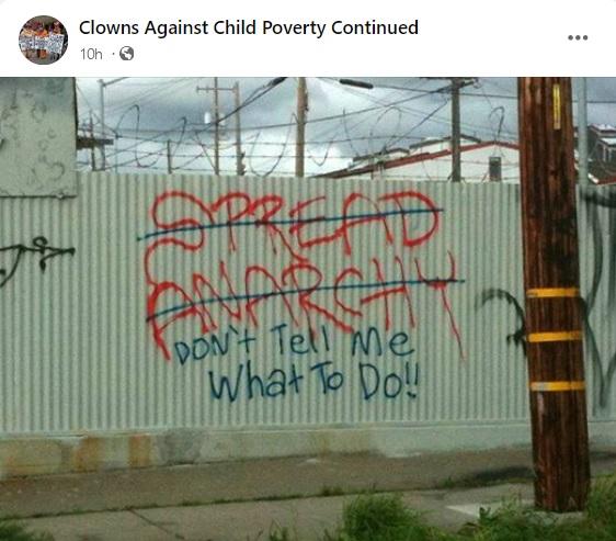 Graffiti says: Spread Anarchy. but that is crossed out and replaced with: Don't tell me what to do