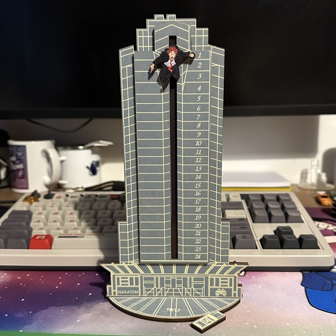 A wooden Nakatomi plaza building with a Hans Gruber that can be moved down for each day. It’s an advent calendar.