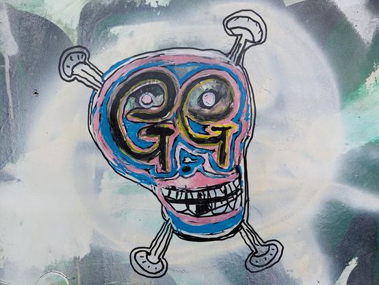 someone's very colorful graffiti doodle of a skull & crossbones, decorated with trans flag colors, with stylized GG's for eyes, and a crude-but-expressive style that feels very reminiscent of Basquiat's Untitled (1982)