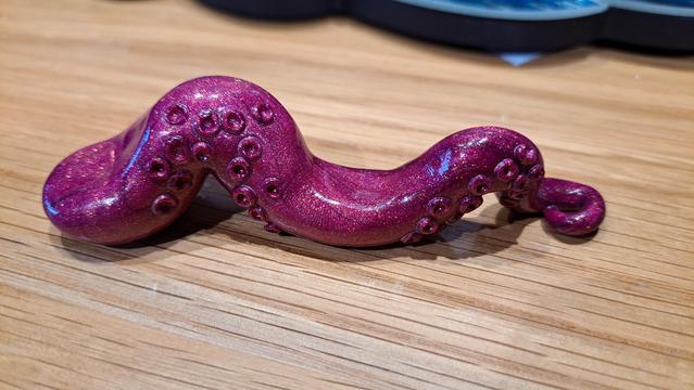 A red clay tentacle brush holder