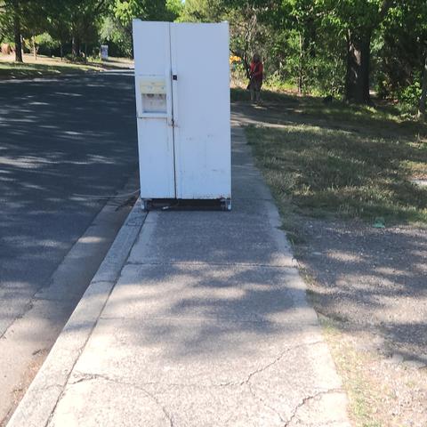 A dumped fridge blocking the side walk in Lyneham