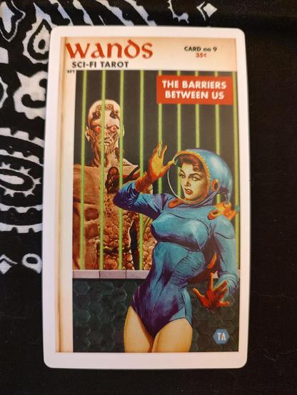 Card from the SciFi Tarot by Todd Alcott.
Nine of Wands.
A woman in a futuristic retro spacesuit, standing in front of what appears to be a cage, the bars made of laser lights. There is an alien creature inside the cage.