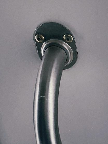 A bar going into a bracket that looks like a face.