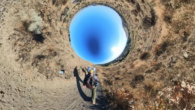 A desert mountain hiking trail scene from the Tri-Cities area of eastern Washington State under clear blue skies.
