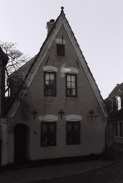 Black and white film photo of a beautiful little old town house in Abenraa