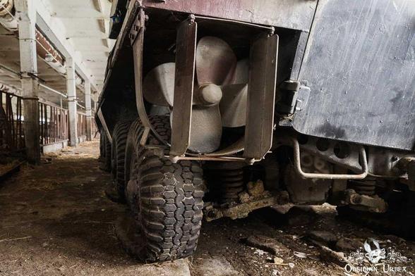Rear view of a military truck, perhaps abandoned. Note the large propeller and tires,