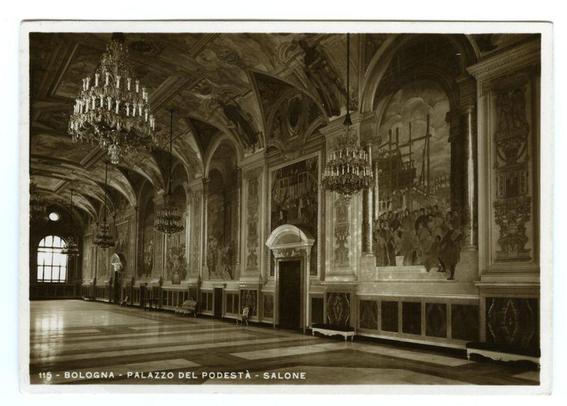 The image depicts an interior view of a grand hall with high ceilings and ornate decor, reminiscent of classical European architecture. The room features large arches on the sides leading to other spaces or corridors, as well as a central arched doorway at one end. The floor is tiled in long horizontal stripes, alternating between lighter and darker shades.

The walls are adorned with elaborate frescoes that depict various scenes, possibly historical events or allegorical representations. Two chandeliers hang from the ceiling; one large ornate fixture on each side of an open window at the far end, while smaller ones cluster around a larger central opening in the middle section. The overall impression is of opulence and grandeur.

The photograph appears to be black-and-white, suggesting it may have been taken several decades ago or intended for artistic effect rather than documentation. Inset text indicates this photo represents "Bologna - Palazzo del Podestà - Salone," which translates from Italian as Bologna - Palace of the Mayor's Office - Hall.

The image captures a historical and cultural snapshot, likely representing an important public building in Italy during its time period or for promotional purposes to showcase architectural beauty.