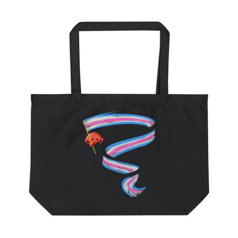Large black tote bag with Ferris the Rustacean waving a long trans flag banner printed on it