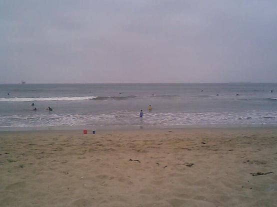 Old photo of the Santa Barbara shoreline on a cloudy day.