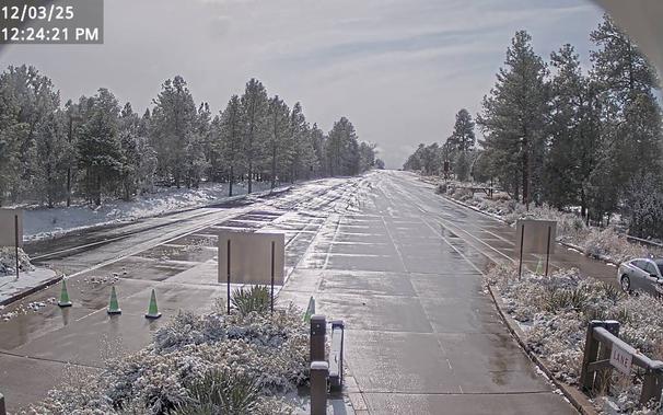 To help time your South Rim arrival, monitor the South Entrance Station Webcam. During busy weekends, there can be long lines and up to two hour wait times between 10 am - 5 pm. This view refreshes every minute. The entrance station is about 1.6 miles (2.5 km) north of the gateway town of Tusayan, AZ.