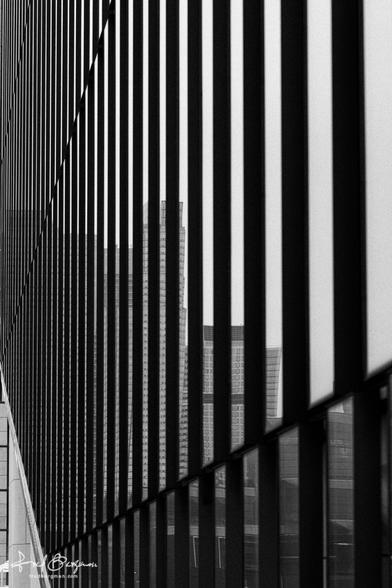 Side view of a steel girder building with lots of windows in a repeating pattern