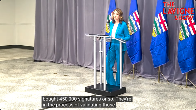 Video shows Alberta Premier Danielle Smith behind a lectern on Day 2 of the UCP's AGM answering a question from Jason Lavigne on November 29th, 2025 after her keynote speech. The Lavigne Show logo is in the top-right corner of the video, and the Closed Captioning reads: "bought 450,000 signatures or so. They're in the process of validating those"