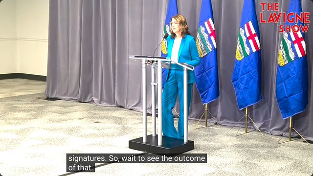 Video shows Alberta Premier Danielle Smith behind a lectern on Day 2 of the UCP's AGM answering a question from Jason Lavigne on November 29th, 2025 after her keynote speech. The Lavigne Show logo is in the top-right corner of the video, and the Closed Captioning reads: "signatures. So, wait to see the outcome of that."