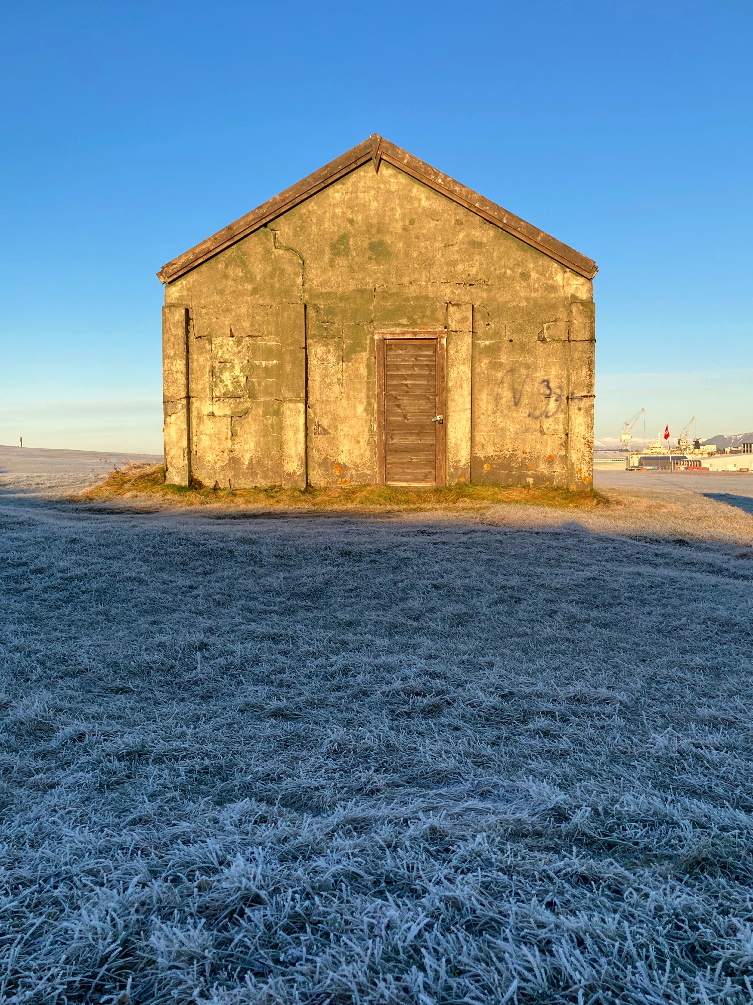 An old shed on a frozen golf course.