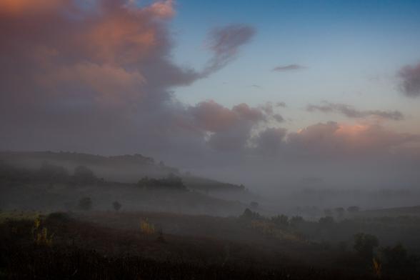 rolling hills covered in mist on a foggy dawn in portugal