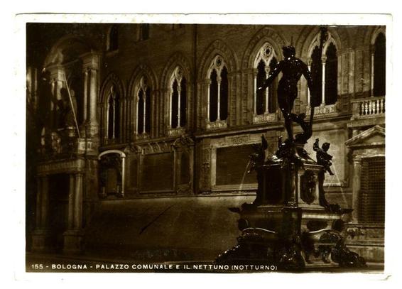 The image depicts a historical scene in Bologna, Italy. It features the Palazzo Comunale and Il Nettuno (Nettuno), which is likely an artistic statue or fountain named Nettuno that appears prominently on a pedestal. The photograph has a sepia tone typical of old photographs from the early 20th century, suggesting it's historical in nature.

The setting seems to be at night due to the dim lighting and shadows cast by what could be artificial light sources. Gothic architectural elements are visible with pointed arches, detailed stonework, and large arched windows that characterize a medieval or Renaissance building style typical of public buildings from Bologna during this period.

There is no movement in the scene; it's still, yet there’s an impression of life within its static structures – perhaps signifying history, tradition, culture. The photograph captures only part of what looks like a wider architectural context with more arches and columns leading into the distance beyond the frame.

The caption below indicates that this image is likely from a specific collection or series related to Bologna’s night-time views (notturno), possibly highlighting its historical architecture and landmarks in low-light conditions.