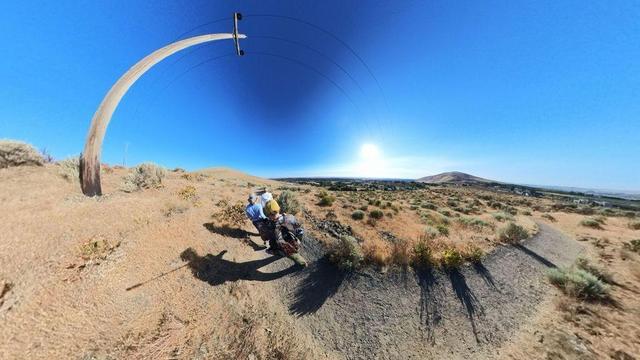 A desert mountain hiking trail scene from the Tri-Cities area of eastern Washington State under clear blue skies.