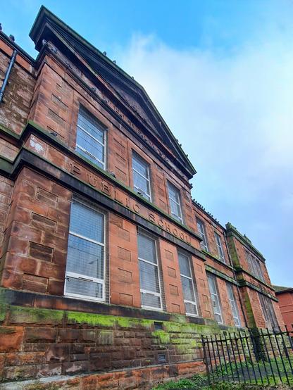 A femce in a 1915 public school in Glasgow which once divided the boys half of the playground from the girls half.
