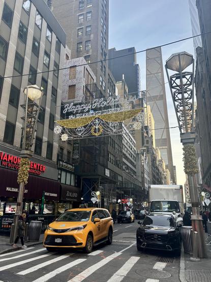 Holiday light-up sign over the block called the Diamond District. A NYC yellow cab is seen.