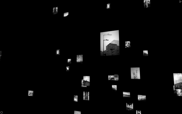 Screenshot of the 3D installation showing black and white urban images of Berlin floating in a black space.