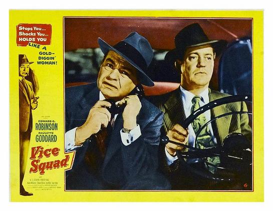 Main image: two men in a car, one driving and one on a phone call. Also a smaller image of a man holding a pistol. Text: "Stops you…Shocks you…Holds you like a gold-diggin' woman!"