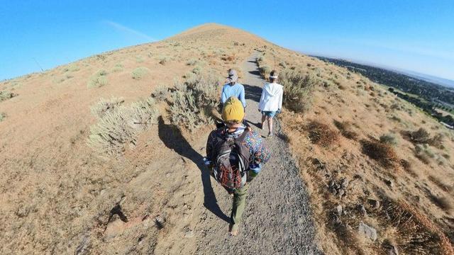 A desert mountain hiking trail scene from the Tri-Cities area of eastern Washington State under clear blue skies.