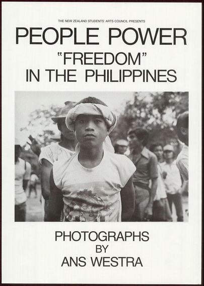 Black and white poster for an exhibition titled "People Power: Freedom in The Philippines" by Ans Westra. A young man with a cap, wearing a shirt depicting the pop singer Madonna, is featured on the photograph at the bottom of the poster as well as being part of the crowd seen behind him.
The top section has bold typeface stating “NEW ZEALAND STUDENTS' ARTS COUNCIL PRESENTS” and below it in even bolder font “PEOPLE POWER 'FREEDOM' IN THE PHILIPPINES". The bottom right reads "PHOTOGRAPHS BY ANS WESTRA" with the photographer's name being more prominent than his work.