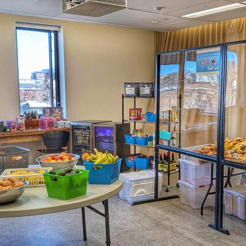 Tables, shelves, and mini fridges of food at the weekly Distro