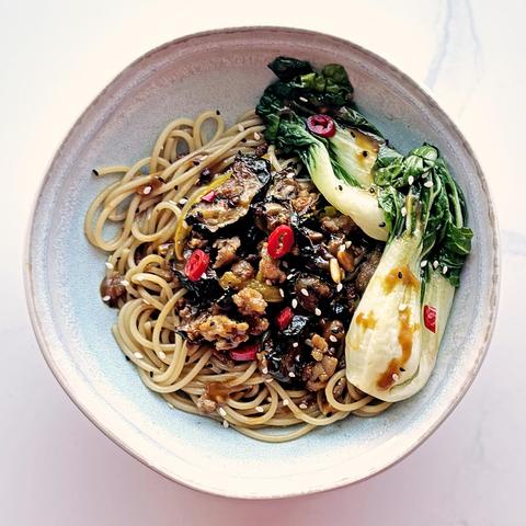 Peanut Sesame noodles made with leftover pork, roasted courgettes, onions, on spaghettini, topped with blanched baby bok choi and sliced chillies.