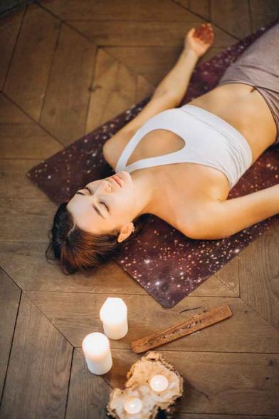 woman relaxing in yoga mat