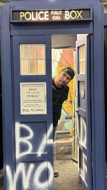 Me peering out of a live-size model of the TARDIS from Doctor Who.