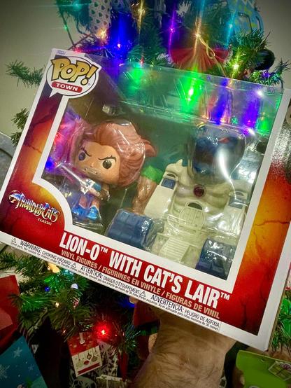 Thunder Cats Lion-O and Thunder Cats Lair Funko Pops photographed in front of Christmas Tree with lights