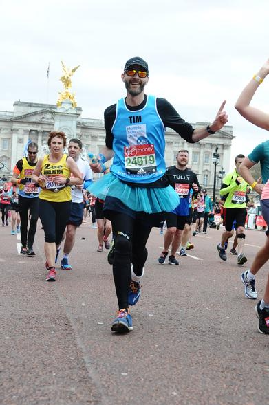 It’s a lanky guy wearing a blue MS Trust vest and a blue tutu. He’s raising a finger in the air and has Buckingham Palace behind him as he enters the last mile or so of the London Marathon in 2016. My left leg is heavily strapped to keep my shitty ankle working for as long as possible.