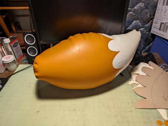 A view of the left side with the base of the tail in focus. The seam wrinkles are a bit less pronounced and the curvy shape of the tail is a bit more apparent.