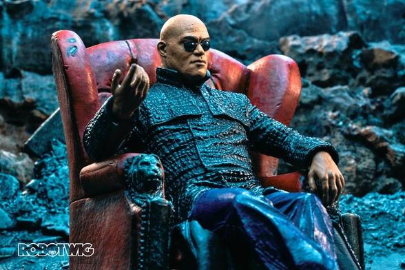 Morpheus sits on a red leather chair against a background of rubble