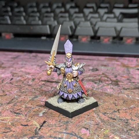 An elf in purple and silver holding a sword