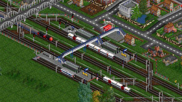 ๐ถ๏ธ A bird's eye view of a station where several suburban or freight trains are approaching or parked, overlooked by a footbridge and a bridge. Near the station a road network and suburban dwellings. The graphics are a bit pixelated considering the age of the game and the close-up.
๐๏ธ Open Transport Tycoon is a libre, multi-platform, single-player / multi-player (up to 255) business simulation game, based and compatible (but autonomous & enhanced) with the Transport Tycoon Deluxe game (1994). The player builds his transport network (trucks, buses, trains, planes & ships) to transport passengers and freight, with the goal of being as profitable as possible. The dividends received by these transports can be reinvested in the extension of the network or the acquisition of vehicles. A mature and actively maintained project.