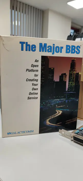 Front side of The Major BBS box from Galacticomm. It has a photo of a town in the right and a description on the left saying: "An Open Platform for Creating Your Own Online Service".