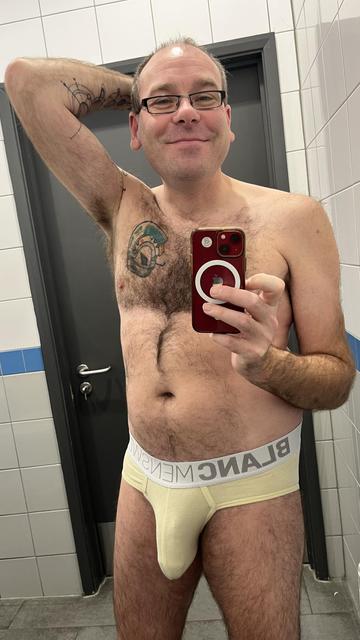Hairy gay guy wearing yellow Blanc briefs with white waistband