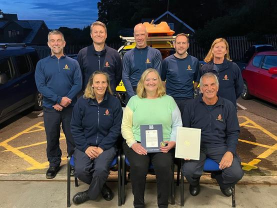 <img alt="US Coast Guard Presents Award to South Wales Coastguard ‘Heroes’" src="https://www.goodnewspost.co.uk/content/images/2025/12/image-35.jpeg" /><p><strong>By Community Correspondent</strong></p><p><strong>An American Coast Guard has returned to the scene of her accident in South Wales, a year after a significant ankle injury saw her rescued by Coastguards from Penarth Coastguard Rescue Team. </strong></p><p>US Coast Guard Dr Cynthia Woodlock was visiting South Wales when she fell and sustained a serious ankle injury at Sully Bay in the Vale of Glamorgan last September.</p><p>The scientist and engineer, who works within the US Coast Guard’s Hazardous Materials Division in Washington DC, was visiting the UK for an annual International Maritime Organization meeting and had decided to use some of her free time to visit the coast.</p><h2 id="cindy-was-rescued-by-coastguard-rescue-officers-from-penarth-coastguard-rescue-team-who-removed-her-from-the-beach-amid-rising-tides">Cindy was rescued by Coastguard Rescue Officers from Penarth Coastguard Rescue Team, who removed her from the beach amid rising tides.</h2><p></p><blockquote> “I want to thank the team for getting me off that beach. I’ll never forget the relief I felt at seeing the Coastguards' headlamps bobbing across the sand,” <strong>she said.</strong></blockquote><p>Cindy had sustained multiple ankle fractures and, breaking her tibia, fibula and heel